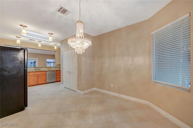 interior space with visible vents, a sink, baseboards, and light tile patterned flooring