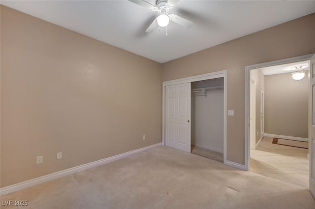 unfurnished bedroom with a ceiling fan, a closet, light colored carpet, and baseboards