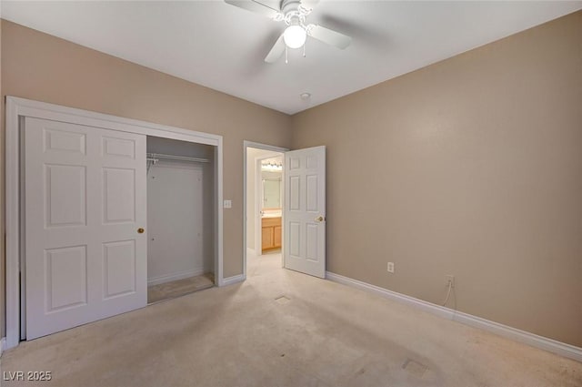 unfurnished bedroom with light carpet, ceiling fan, a closet, and baseboards