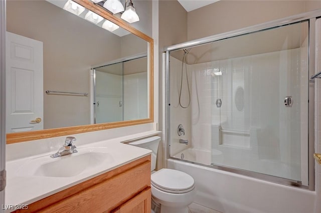 full bath featuring bath / shower combo with glass door, vanity, and toilet