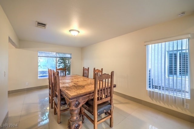 dining space featuring light tile patterned flooring