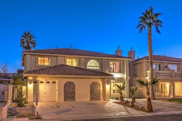 mediterranean / spanish-style house with a garage