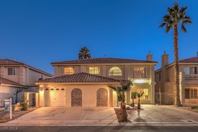 mediterranean / spanish-style home with a garage