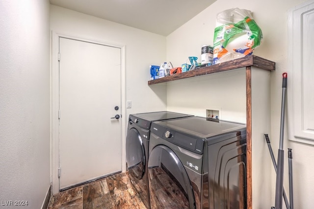 clothes washing area with washer and dryer and dark hardwood / wood-style floors