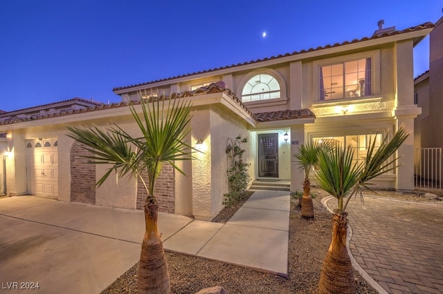 mediterranean / spanish house featuring a garage