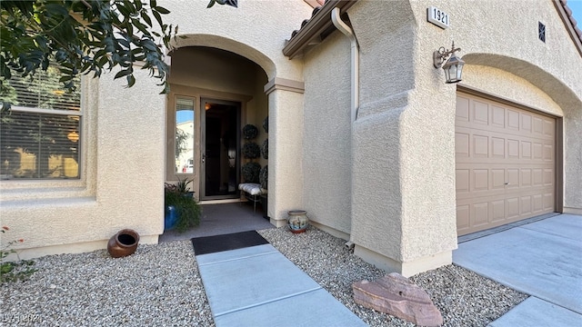 view of exterior entry with a garage