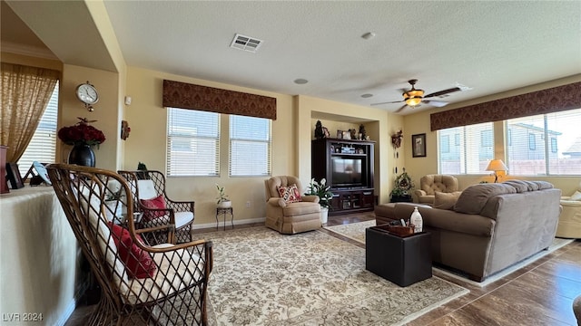 living room featuring a textured ceiling and ceiling fan