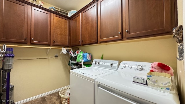 laundry area featuring washing machine and dryer and cabinets