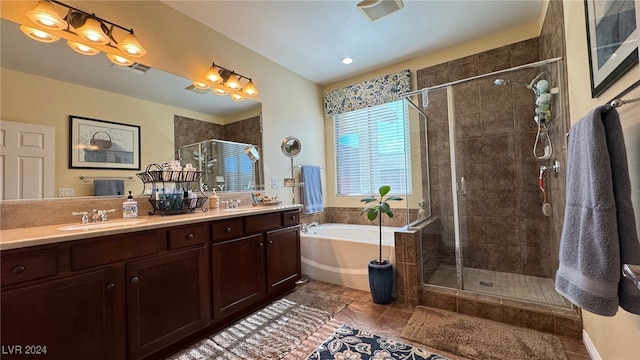 bathroom with tile patterned flooring, vanity, and plus walk in shower