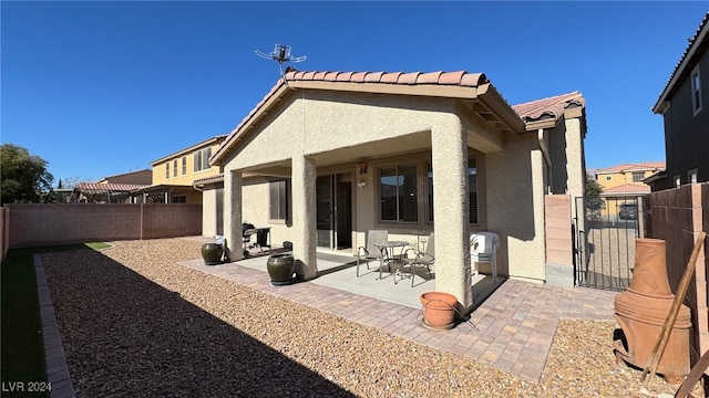 rear view of property with a patio area