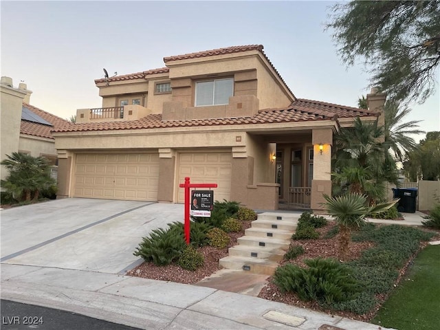 mediterranean / spanish house with a garage