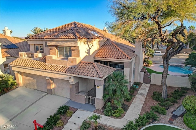 mediterranean / spanish-style home featuring a garage and a balcony