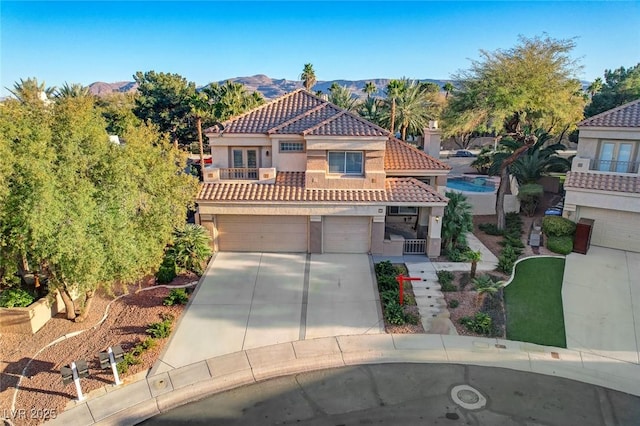 mediterranean / spanish-style house featuring a mountain view and a garage