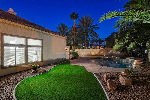 yard at twilight featuring a fenced in pool and a patio area