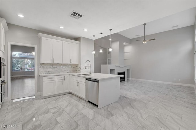 kitchen with white cabinets, kitchen peninsula, sink, and dishwasher