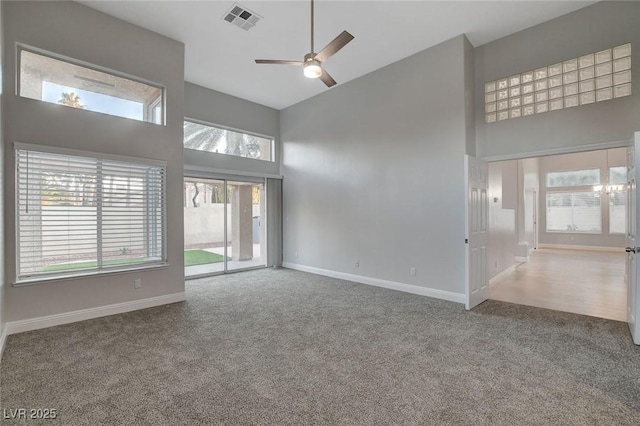 unfurnished room featuring a high ceiling, carpet flooring, and ceiling fan