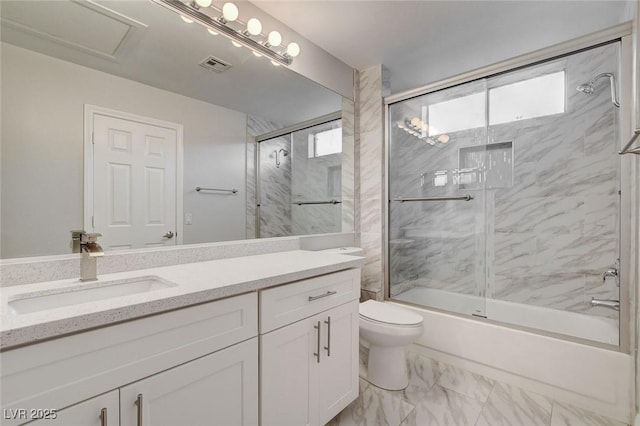 full bathroom featuring vanity, toilet, and combined bath / shower with glass door