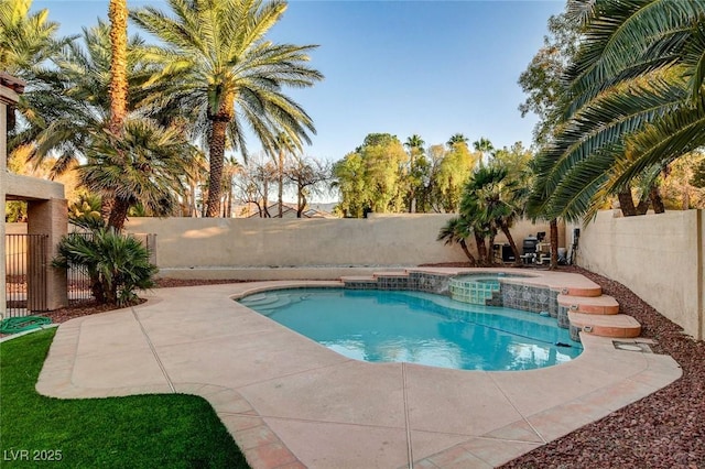 view of swimming pool with an in ground hot tub and a patio area