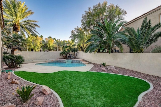 view of swimming pool with a lawn and a patio