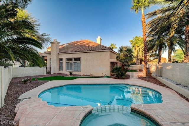 view of swimming pool with an in ground hot tub