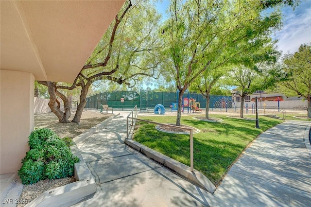 view of property's community with a playground and a lawn