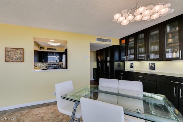 dining space featuring a textured ceiling