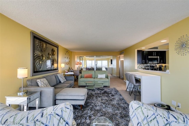 carpeted living room with a textured ceiling