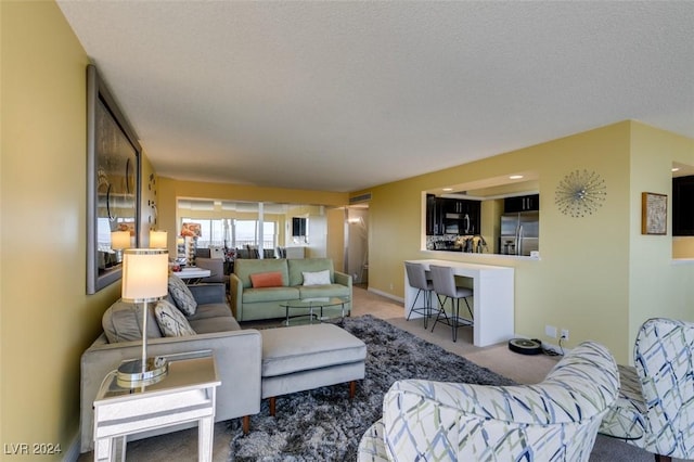 carpeted living room with a textured ceiling