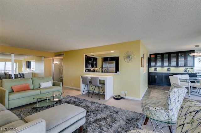 carpeted living room featuring a textured ceiling