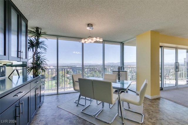 dining space featuring a textured ceiling and floor to ceiling windows