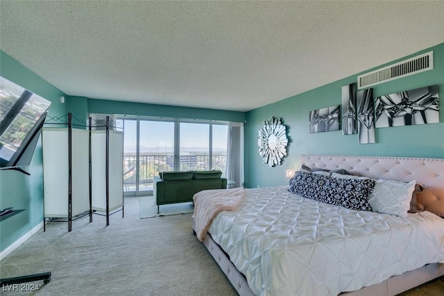 carpeted bedroom featuring a textured ceiling