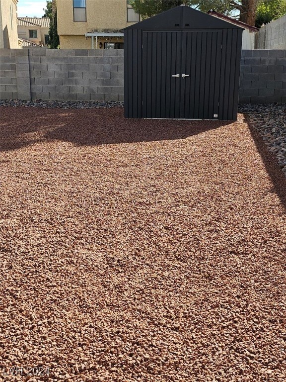 2801 Willow Wind Ct, Las Vegas, NV 89117 - view of yard with a storage shed, fence, and an outbuilding