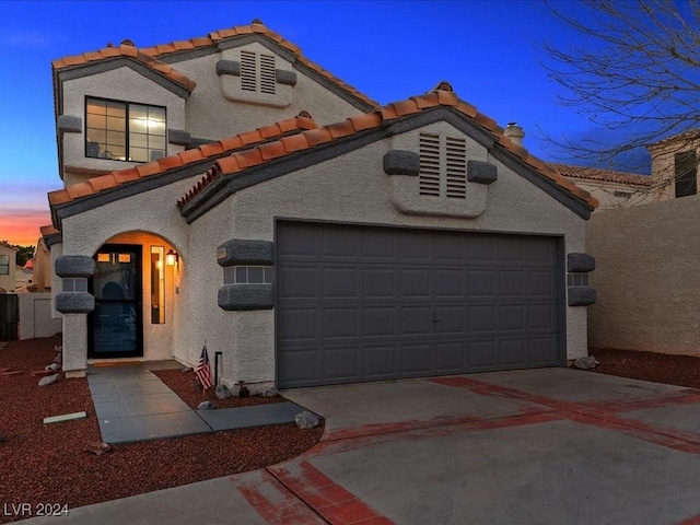 mediterranean / spanish house featuring a garage