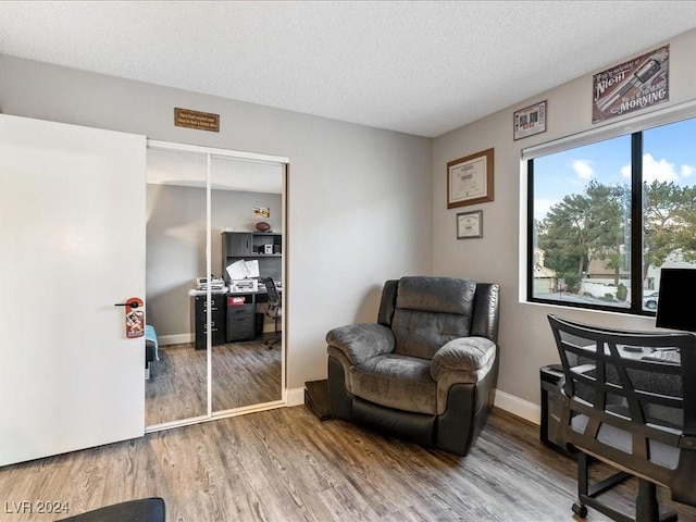 office with a textured ceiling and hardwood / wood-style floors