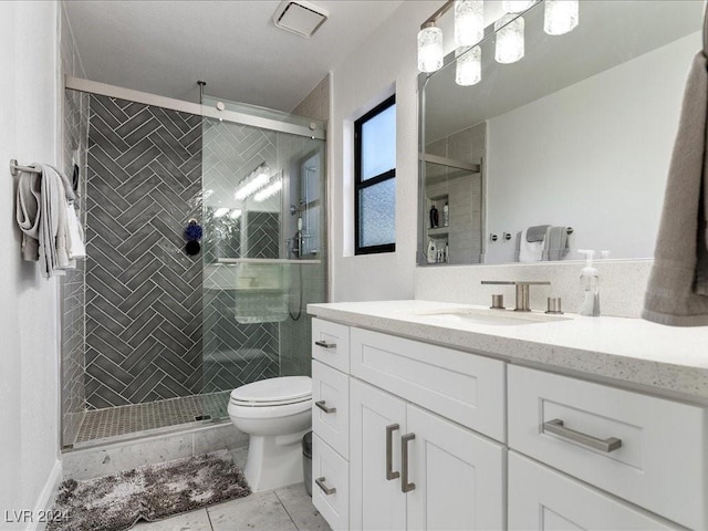 bathroom with toilet, tile patterned flooring, a shower with shower door, and vanity