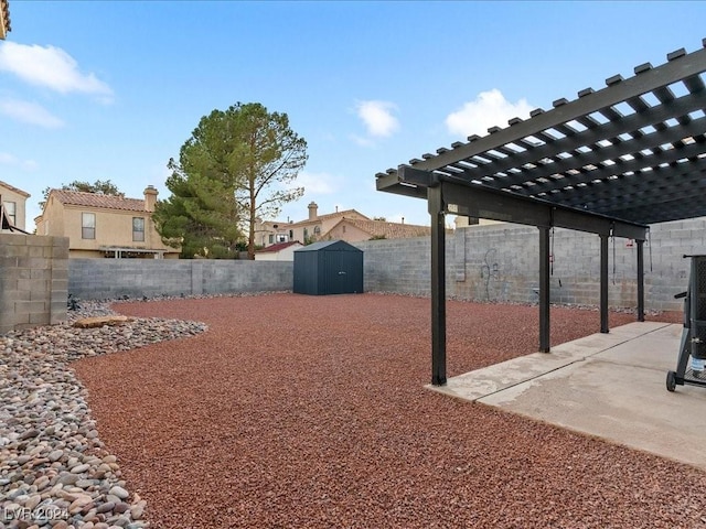 view of yard with a storage unit, a pergola, and a patio