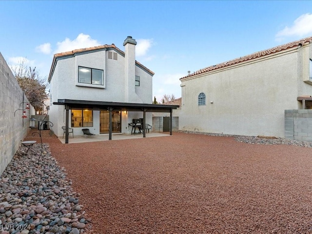 rear view of property with a patio area