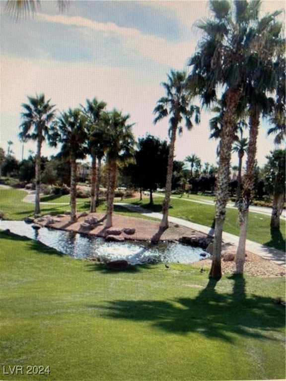 view of community with a yard and a water view