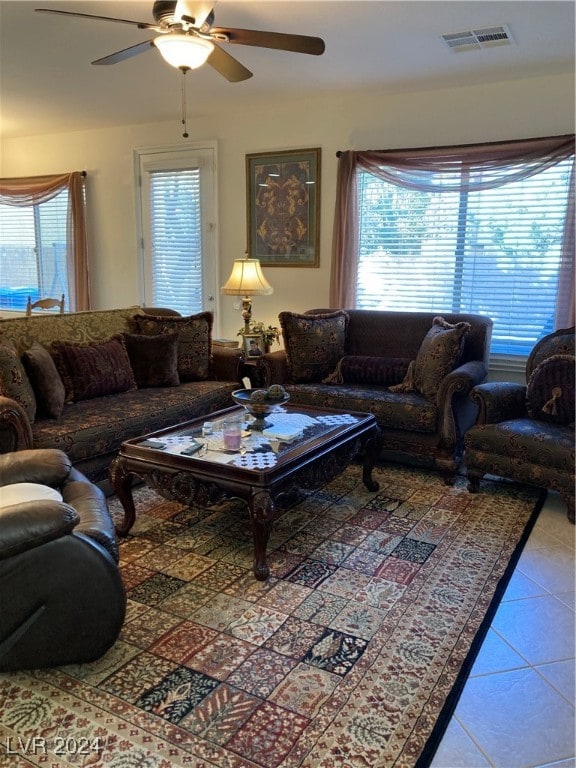 tiled living room featuring ceiling fan