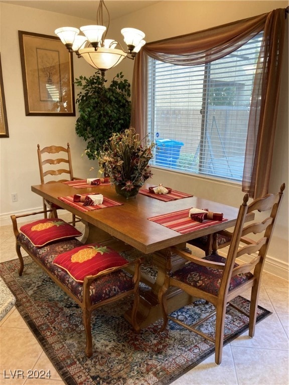 tiled dining area with a chandelier