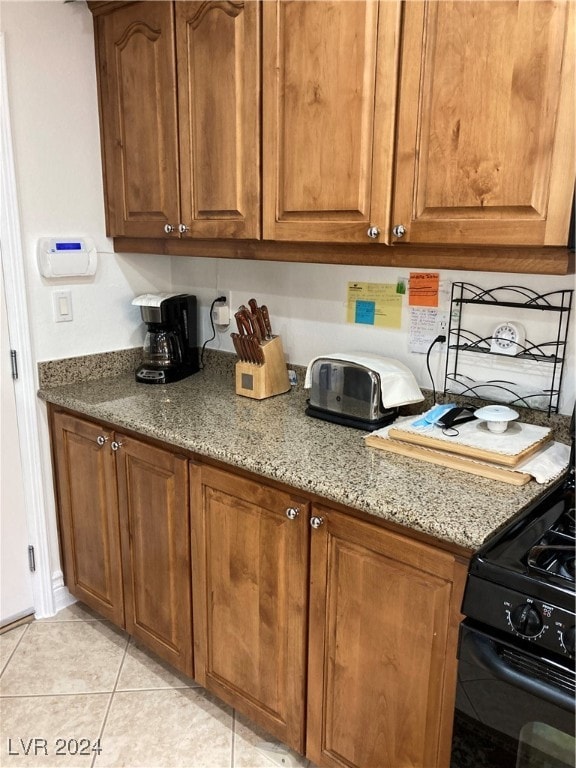 kitchen featuring light stone countertops and light tile patterned floors