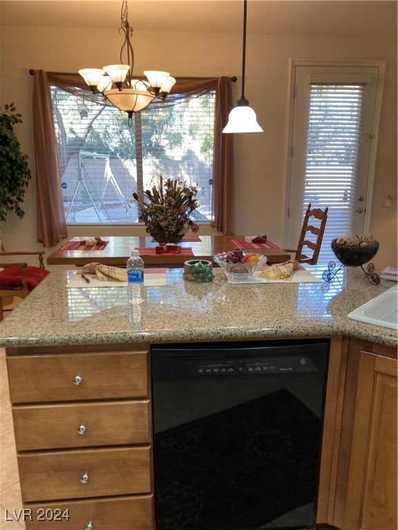 kitchen featuring dishwasher, a healthy amount of sunlight, pendant lighting, and an inviting chandelier