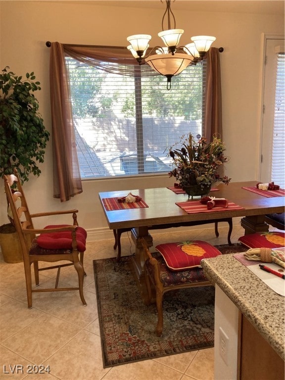 tiled dining space featuring an inviting chandelier