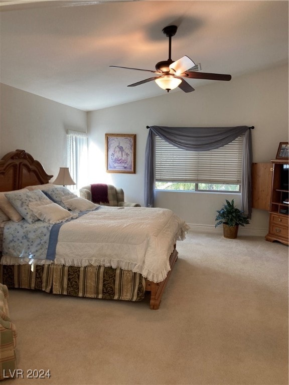 bedroom with ceiling fan, carpet flooring, and lofted ceiling