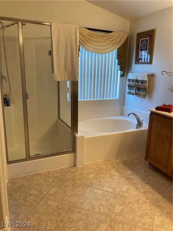 bathroom with tile patterned flooring, shower with separate bathtub, and vanity