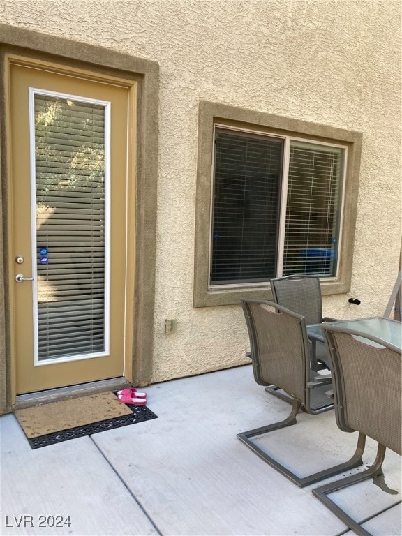 doorway to property featuring a patio area