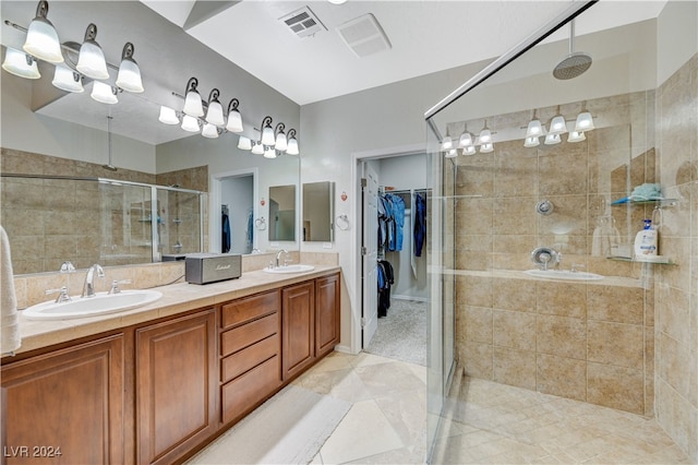 bathroom featuring tile patterned flooring, vanity, and a shower with shower door