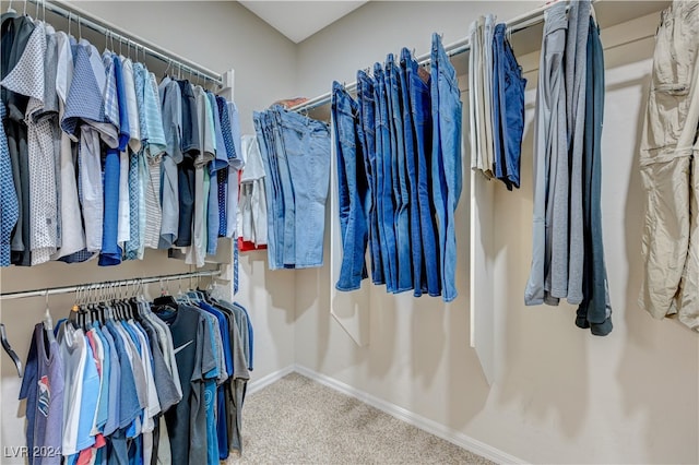 walk in closet with carpet