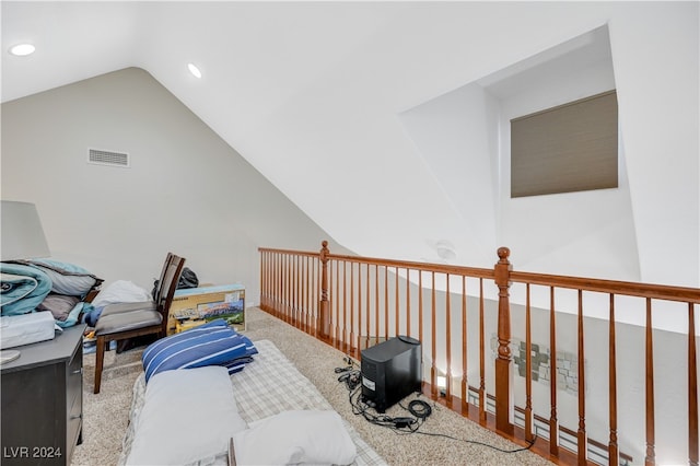 interior space featuring lofted ceiling, carpet, and a baseboard heating unit