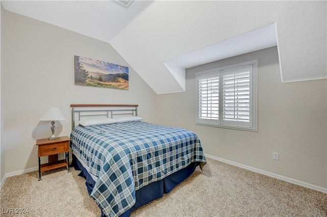 carpeted bedroom with vaulted ceiling